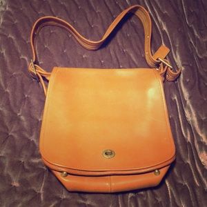 Tan genuine leather Coach cross body bag.